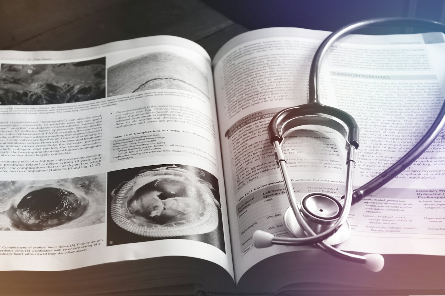 Libro di testo di medicina con diagrammi cardiaci e stetoscopio.